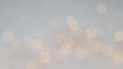 Pale orange blurred lights on white snow background Stock Footage 323847256