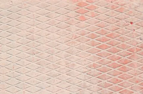 Pale pink concrete in a diamond pattern. Background. Stock Photos