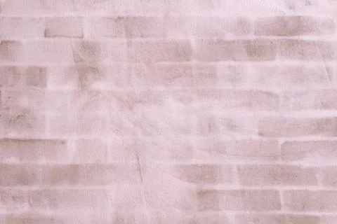 Pale pink wall featuring an abstract brick pattern creating a soft, texture.. 스톡 사진