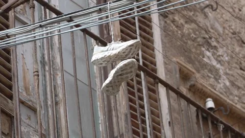 Palermo Shoes Hanging Over Rustic Balcony. Stock Footage 328478603
