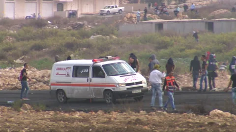 A Palestinian ambulance during clashes between protesters and the Israeli army Video stock 65076958
