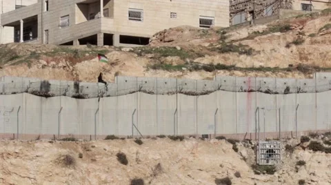 Palestinian Boy wave flag on Security fence Stock Footage 68954385