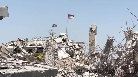 Palestinian Flag Raised on a Destroyed House in Rafah Stock Footage 328028844