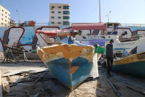 Palestinian maintain and repair the fishing boats using fiberglass materia... Stock Photos