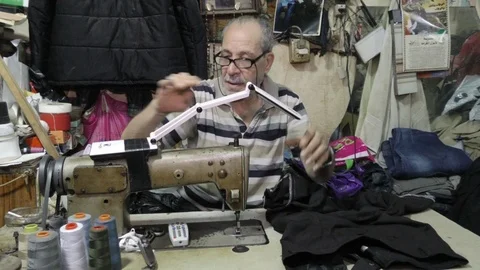 Palestinian tailor at work, Burj Al - Barajneh Palestinian Refugee Camp Stock Footage 120594880