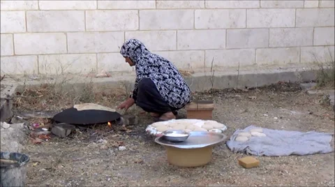 Palestinian woman baking bread on taboon 4 Stock Footage 30394004