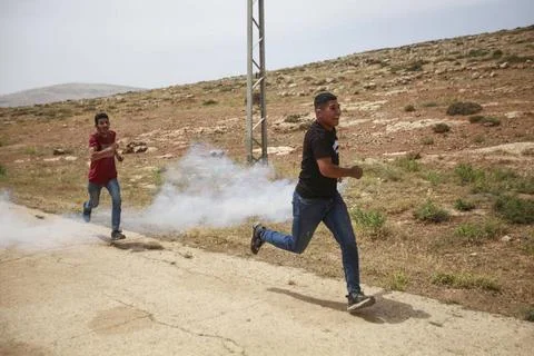  Palestinians react during protests against the establishment of Israeli o... Stock Photos