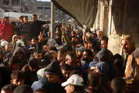  Palestinians wait in crowded queue for long hours to buy bread from the o... 스톡 사진