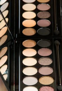 Palette of eye shadow close-up reflected in mirror. Stock Photos