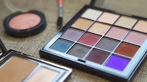 A palette with eye shadows and a makeup brush: women's cosmetics. Stock-Footage 76708642