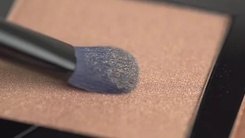 A palette with eye shadows and a makeup brush. Brush gains shiny brown eyes.. Stock Footage 263190890