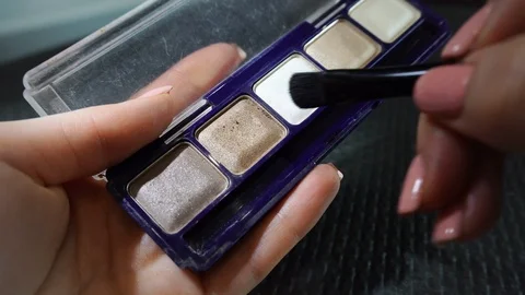 Palette with eyeshadow and makeup brushes, women's cosmetics. Видео 112608083