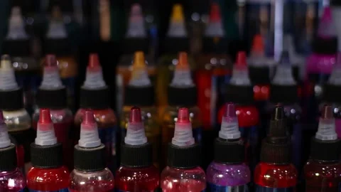 Palette of multicolour tattoo inks in small bottles. Selective focus, blurred. Stock Footage 169521719
