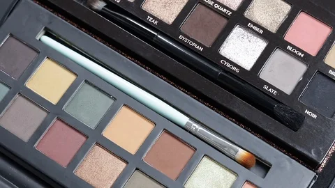Palette of shadows with brushes rotates. close-up Stock Footage 127504706