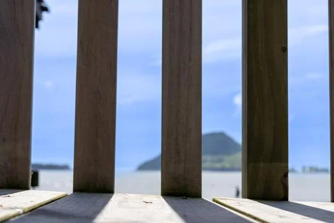 Paling pattern and shadow with bokeh Mount Maunganui in background Stock Photos