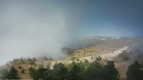 A pall of clouds obscures the earth, a smokescreen, a weather front. Drone Stock Footage 220995408
