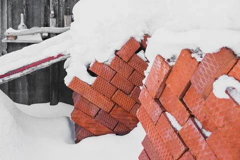 Pallet of bricks for construction under the snow close-up Stock Photos