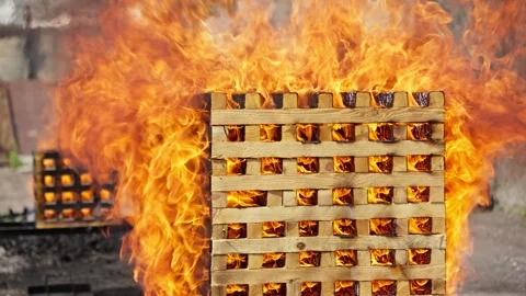 Pallet burning in controlled environment. Intense heat creates fiery inferno Stock Footage 277221280