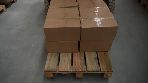 Pallet of goods in boxes moved by warehouse loader Stock Footage 161947594