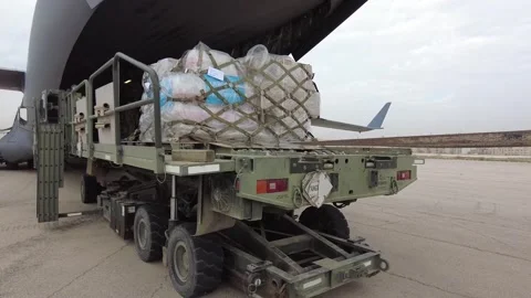 Pallet of humanitarian aid rolling onto C-17 Globemaster aircraft Video stock 257666317
