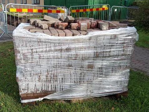 Pallet of Paving Bricks Wrapped in Plastic on Construction Site Stock Photos