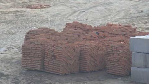 Pallet with red bricks. standing at a construction site. Construction Materials. Stock Footage 120674690