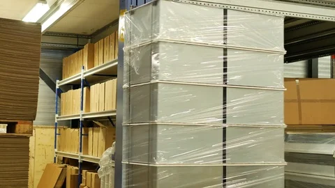 Pallet stretch wrapping machine wraps stainless steel products on a pallet Stock Footage 77590789