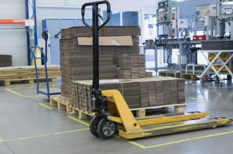 Pallet truck is standing in the assembly hall Stock Photos