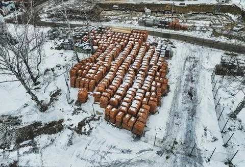 Pallets of bricks for construction. Outdoor storage in winter Stock Photos