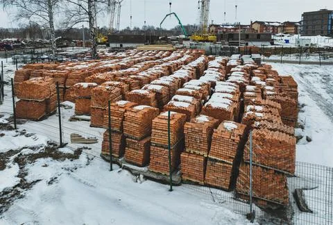 Pallets of bricks for construction. Outdoor storage in winter Stock Photos
