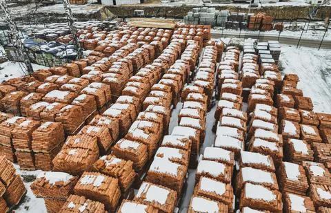 Pallets of bricks for construction. Outdoor storage in winter Stock Photos