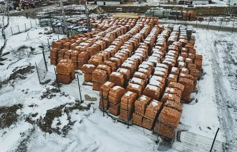 Pallets of bricks for construction. Outdoor storage in winter Stock Photos