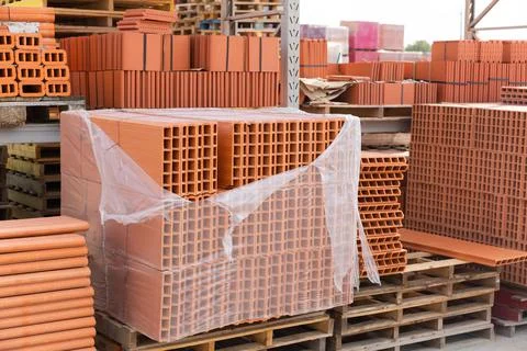 Pallets with bricks in a warehouse of brick factory Stock Photos