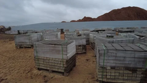 Pallets of building materials stored on a construction site in cloudy weather Stock Footage 337124078