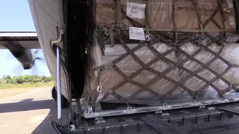 Pallets of cargo rolling off Hercules C-130J  Stock-Footage 83084468