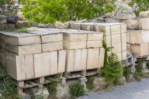 Pallets with marble slabs, storage materials for repairs and construction. Stock Photos