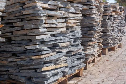 Pallets with natural stone close up. Folded flagstone. Stock Photos