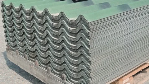 Pallets stacked with corrugated sheets are arranged in a warehouse. The Stock Footage 339095940