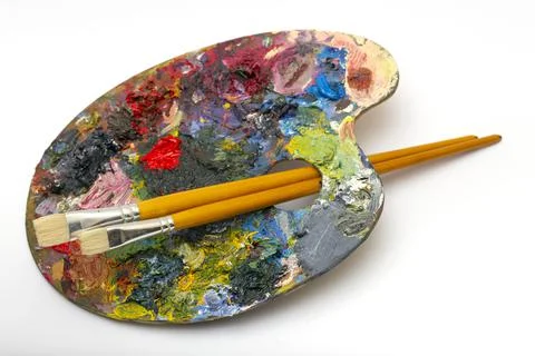Pallette with brushes on a white background Stock Photos