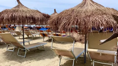 Palm beach umbrellas and sun loungers at the sandy  beach Stock-Footage 246766640