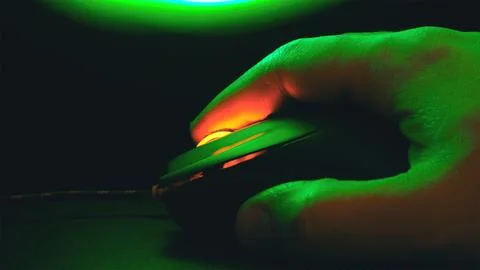 Palm on a computer mouse glowing in the dark Stock Photos