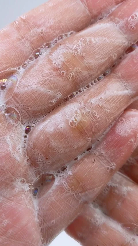 Palm full of soap. Close up of soap foam spreading on hand. Cleansing bubbl.. Stock Footage 335022683