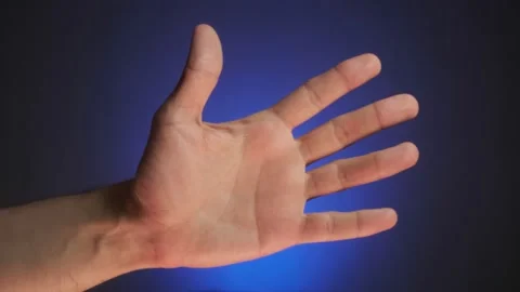 The palm of the hand against a gradient blue background slowly approaches close Stock Footage 155646575