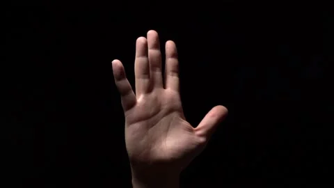 Palm Hands on Black Background. Light on the Hand. Symbol of something Stock Footage 150807101