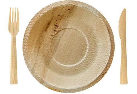 Palm leaf disposable plates with matching birch wood cutlery knife and fork Stock Photos