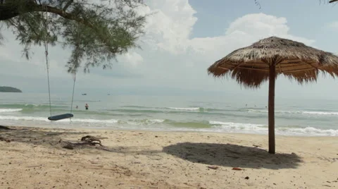 Palm Leaf Parasol Ropes Swing Rocks And Waves Break Stock Footage 43098147
