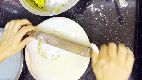 Palm presses gently on round wheat mix in indian kitchen Stock Footage 305960790