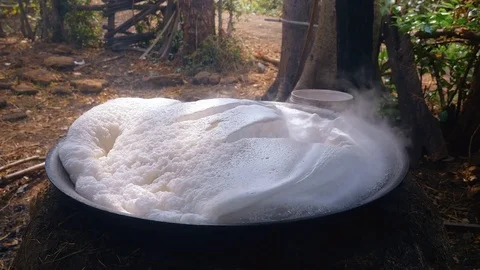 The palm sap from overflowing from the wok. Stock Footage