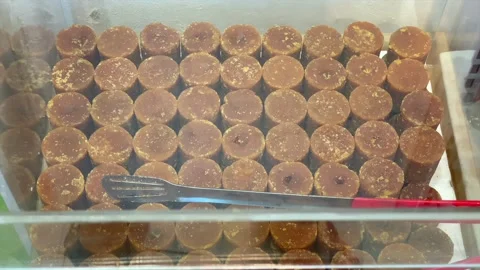 Palm sugar blocks in a glass container at the market Stock-Footage 336977004