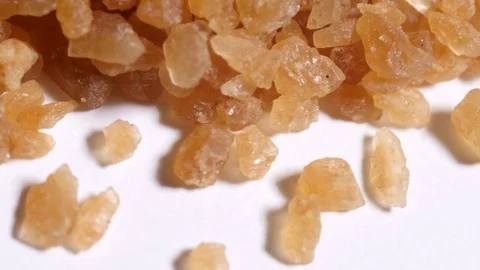 Palm sugar crystals rotating on white background Stock Footage 76569736